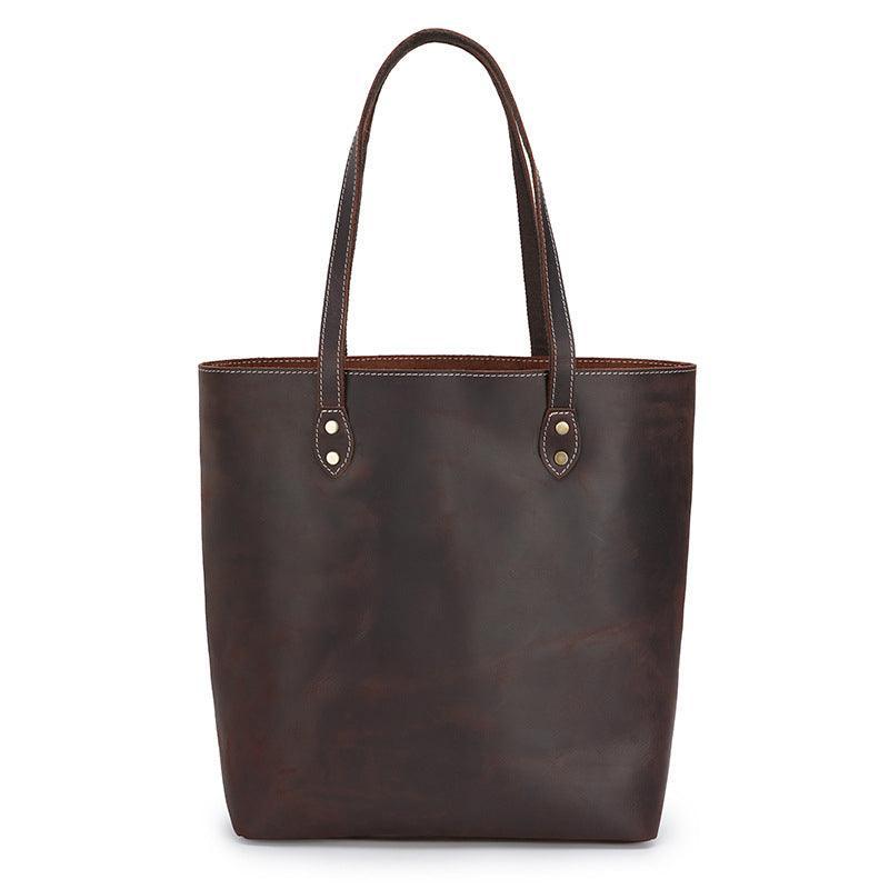 Handcrafted large brown leather tote bag with double handles on a white background