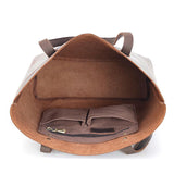 Interior view of a large handcrafted leather tote bag with inner pockets and suede lining