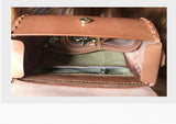 Interior view of handcrafted tan leather shoulder bag with woven stitching and zippered pocket