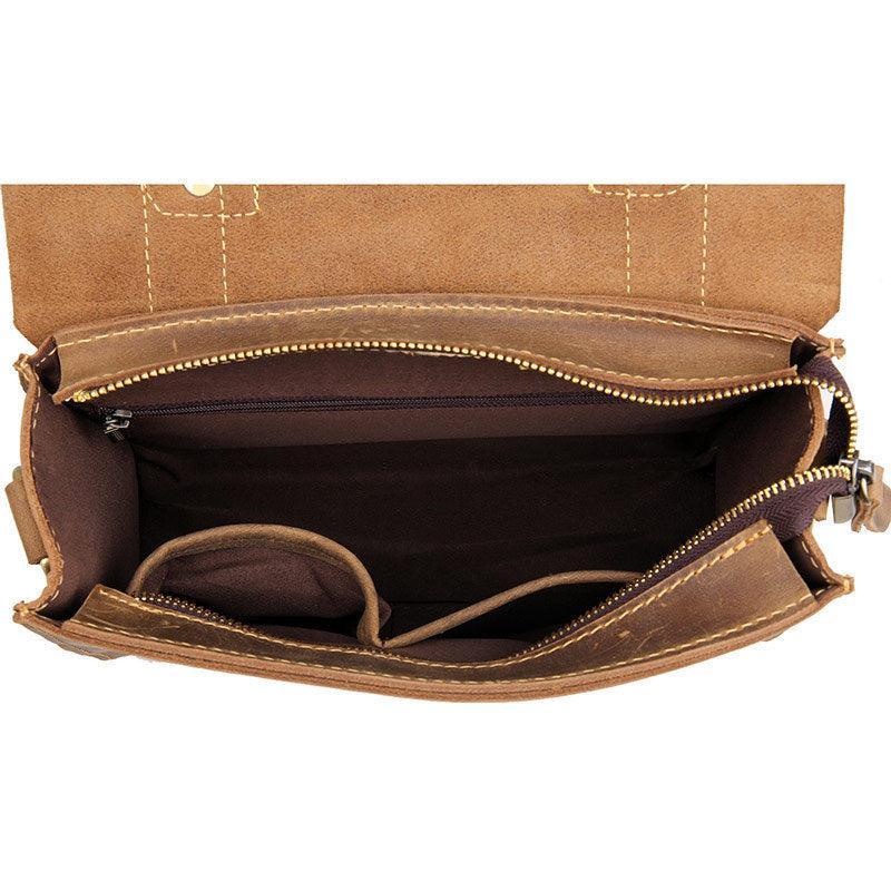 Interior view of a handcrafted brown leather shoulder bag with multiple compartments and zipper pocket