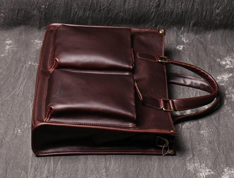 Handmade full grain leather messenger bag with two large front pockets and top handles