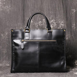 Black full grain leather messenger bag with top handles and front zipper pocket