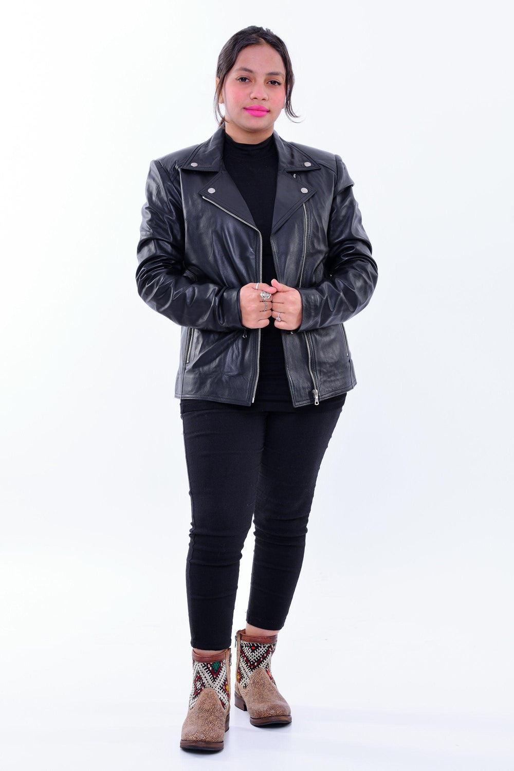 Woman wearing slim fit black genuine leather biker jacket with front zippers