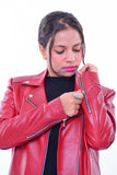 Woman wearing slim fit red genuine leather biker jacket with silver zippers