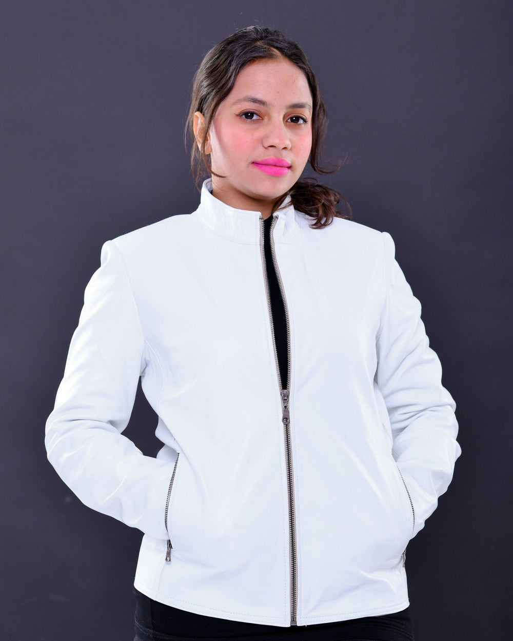 Woman wearing a slim fit white genuine leather biker jacket with front zipper pockets