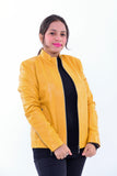 Woman wearing slim fit yellow genuine leather biker jacket, zip front, white background