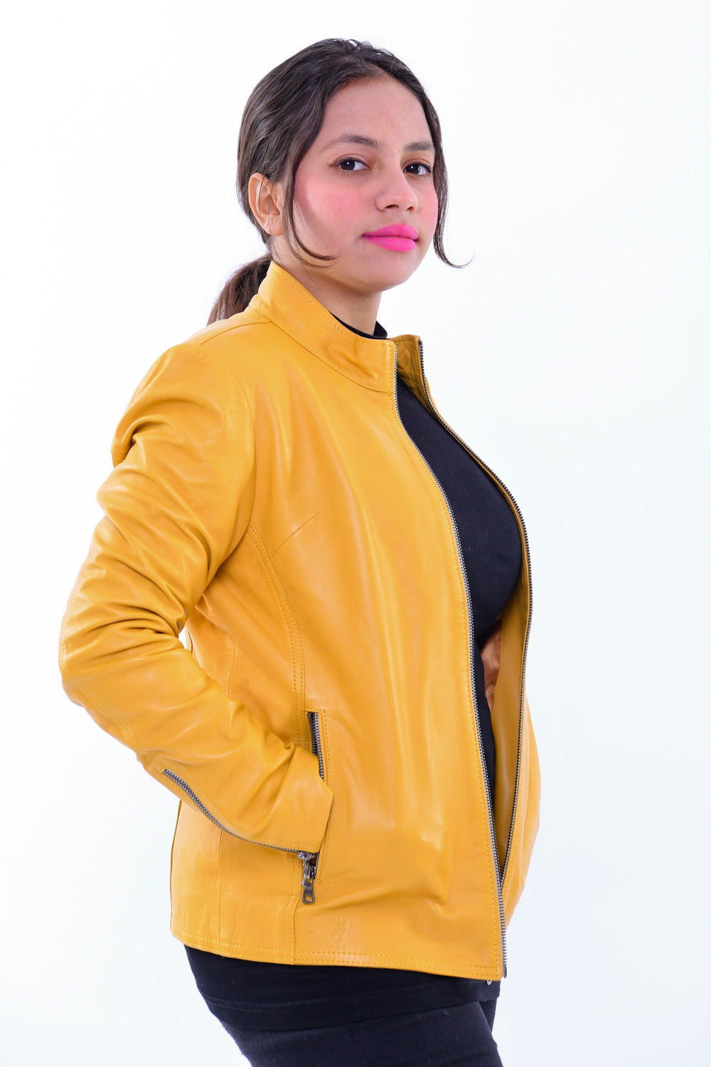 Woman wearing slim fit yellow genuine leather biker jacket with front zipper pockets
