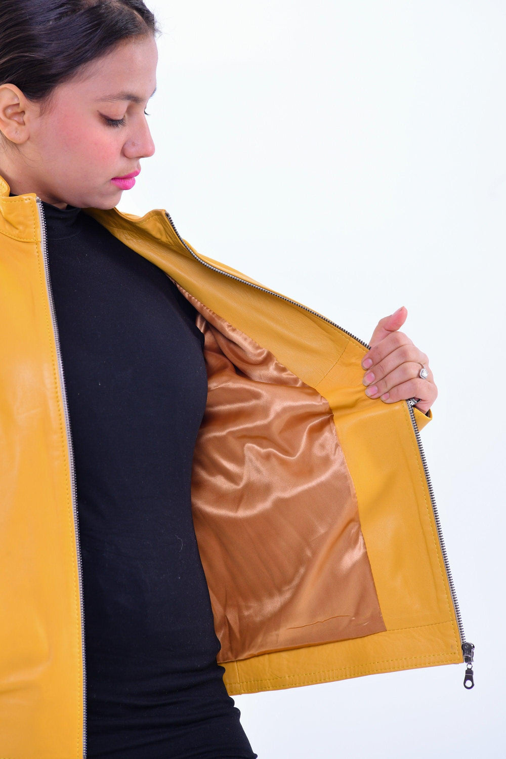 Woman wearing slim fit yellow genuine leather biker jacket showing inner satin lining