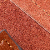 Close-up of brown genuine leather handbag interior with visible stitching and suede texture