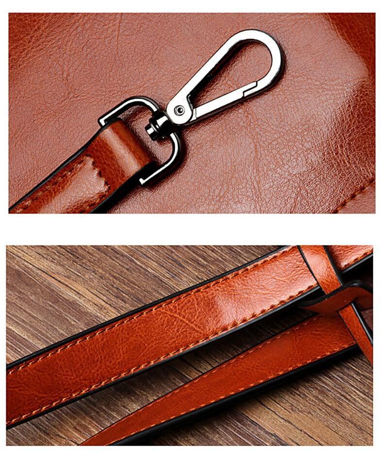 Close-up of brown genuine leather shoulder bag strap with silver hardware and stitching details