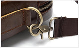 Close-up of brown leather shoulder bag with metal clasp and detachable strap