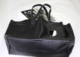 Black full grain leather tote bag with double handles and attached tag on white background