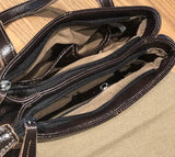 Brown leather crossbody handbag with zippered compartments and beige fabric lining