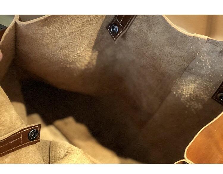 Interior view of large brown distressed leather tote bag with snap closures