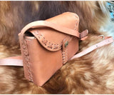 Small handcrafted tan leather shoulder bag with crossbody strap and decorative stitching