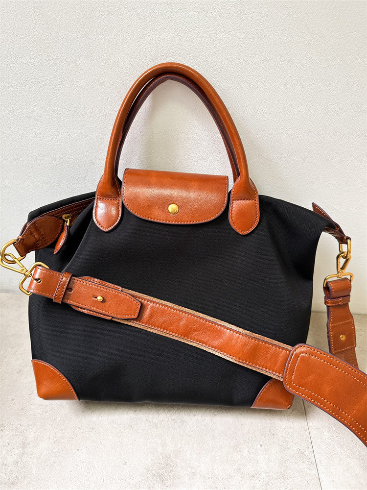 Handmade recycled nylon cowhide tote carried on shoulder – commuter lifestyle shot