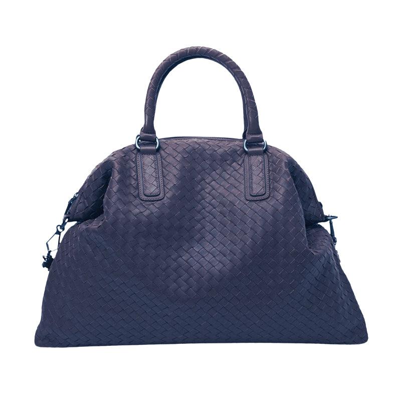 Large woven leather duffle bag with top handles, textured weave pattern, on white background