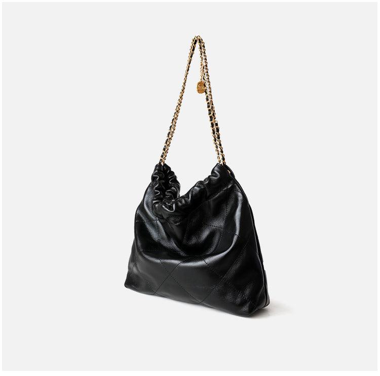 Black quilted calfskin leather shoulder bag with gold chain strap on white background