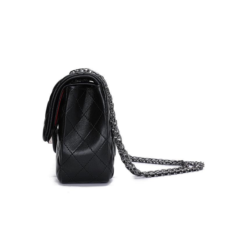 Side view of black quilted genuine leather crossbody shoulder bag with chain strap