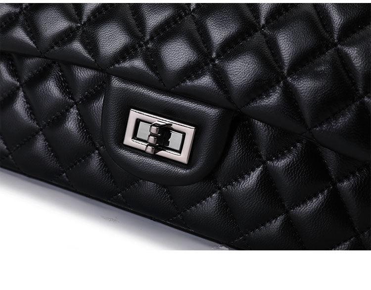 Quilted black genuine leather shoulder bag with silver turn-lock clasp, close-up detail