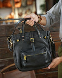 Handmade black cowhide leather shoulder bag with gold hardware and zippered front pocket