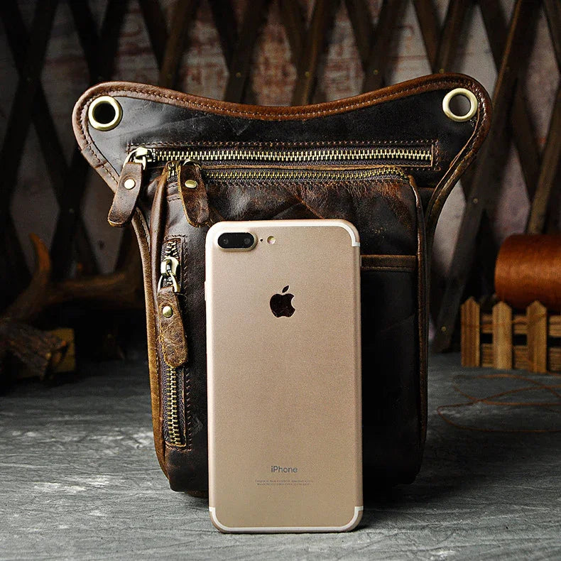 Full grain dark brown leather leg bag with zipper pockets and metal rivet details
