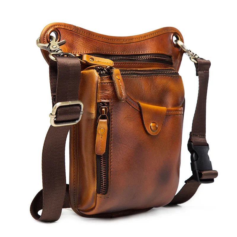 Full grain brown leather leg bag with multiple zippered pockets and adjustable straps