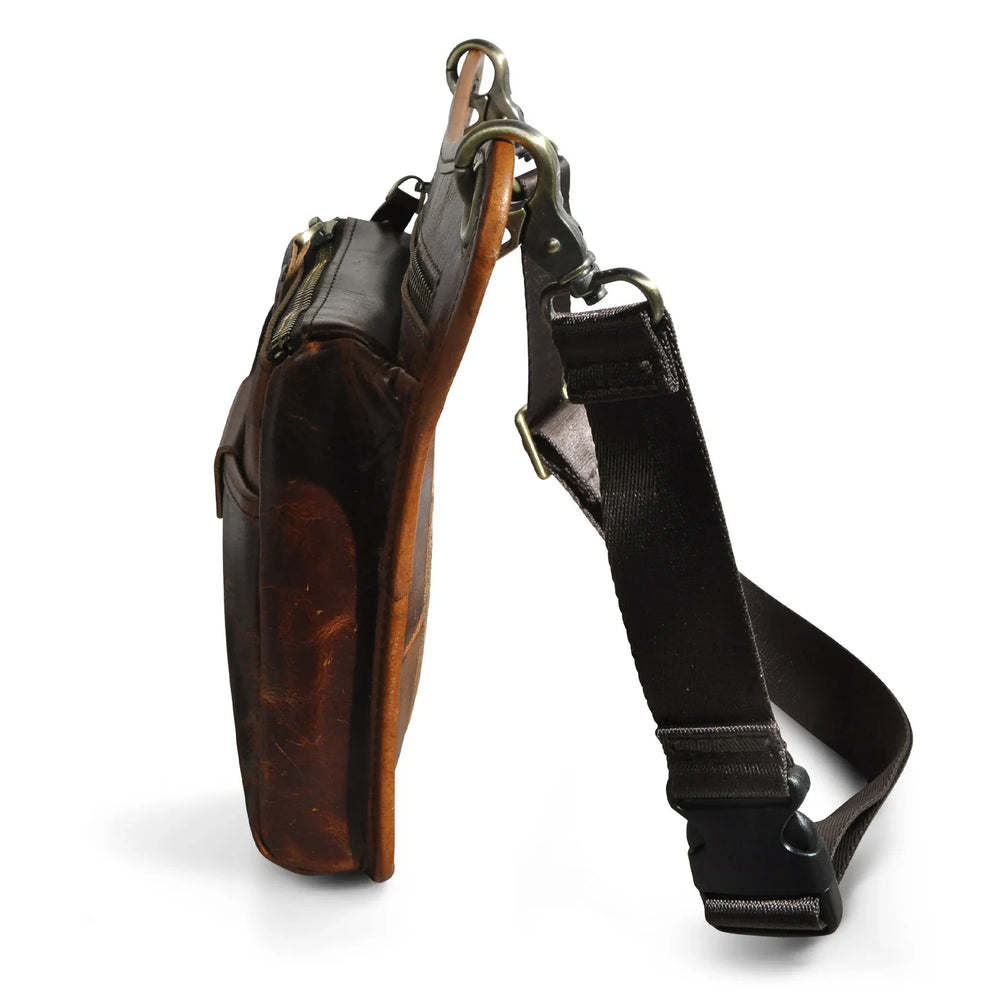 Full grain leather leg bag for men, worn at the waist, with zipper pockets, outdoor setting Red Brown