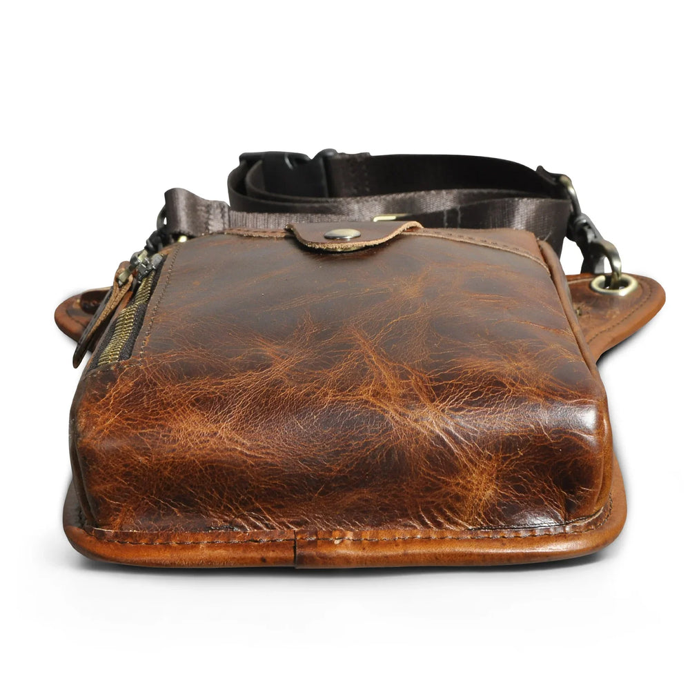 Full grain leather leg bag for men, worn at the waist, with zipper pockets, outdoor setting Red Brown