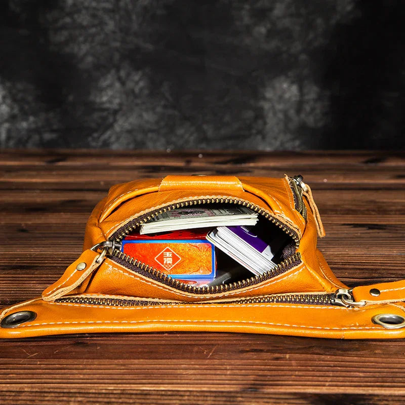 Full grain leather leg bag in brown, open to show storage with cards and small items inside