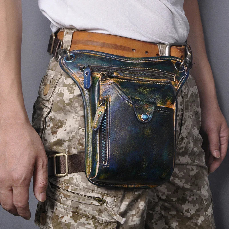 Full grain leather leg bag with multi-zip pockets worn on waist, camouflage pants visible