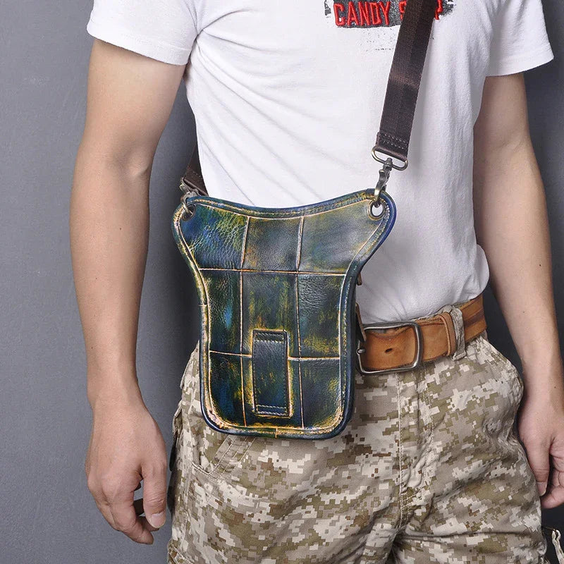 Full grain leather leg bag with multi-zip pockets worn on waist, camouflage pants visible