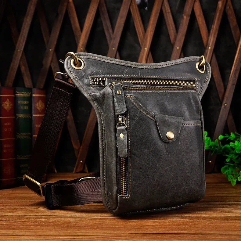 Full grain leather leg bag with zippered pockets and brass snap closures, motorcycle waist pouch dark grey