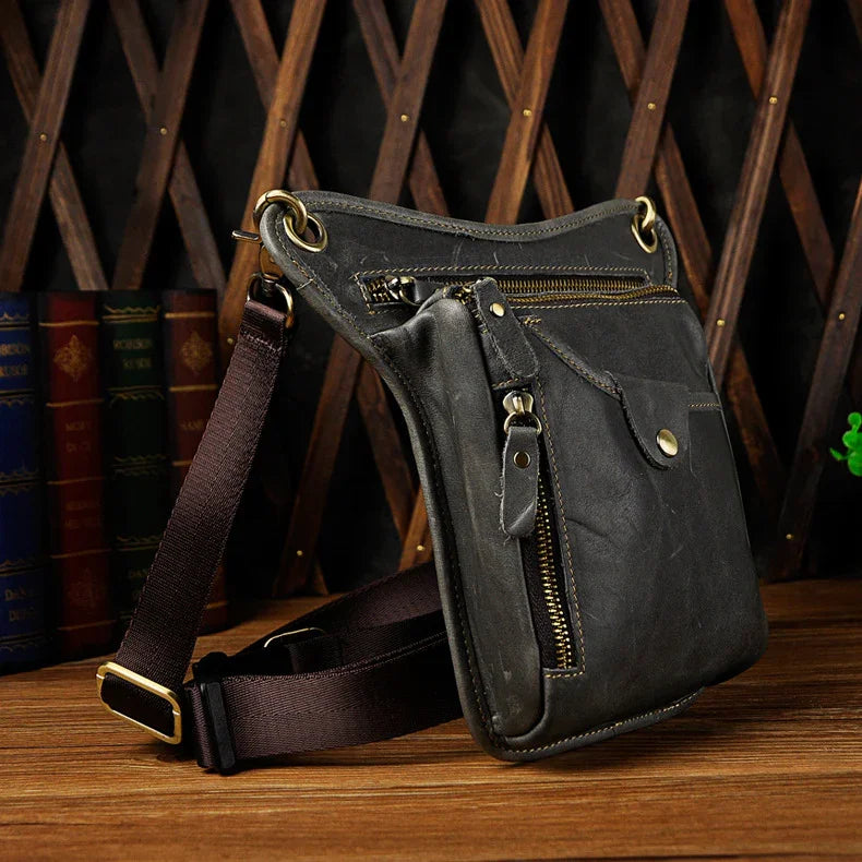 Full grain leather leg bag with zippered pockets and brass snap closures, motorcycle waist pouch dark grey