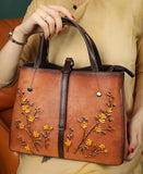 Genuine cowhide leather floral tote bag with embossed yellow flowers and brown handles