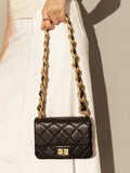 Black quilted leather shoulder bag with gold chain strap and turn-lock closure