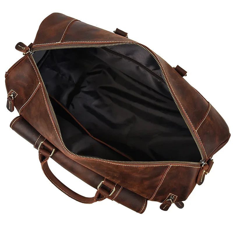 Open handmade full grain leather duffle bag in dark brown with spacious interior and handles