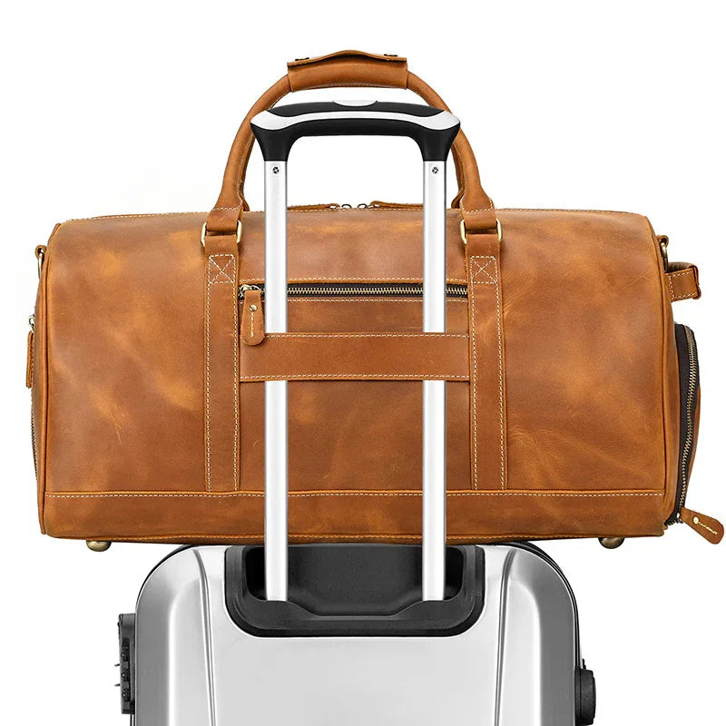 Handmade full grain leather duffle bag in brown with shoe compartment on suitcase