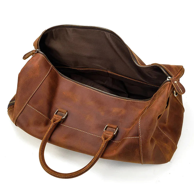 Handmade full grain leather duffle bag in dark brown with spacious interior and handles
