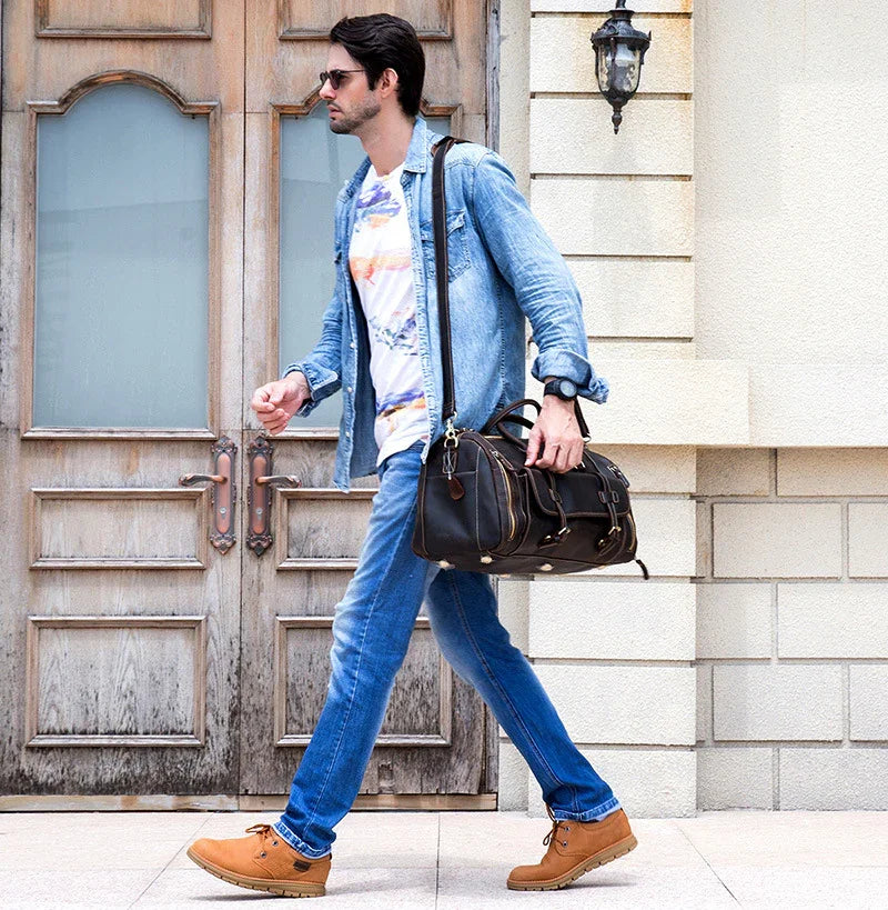 Man walking with dark brown full grain leather duffle bag, travel bag with shoe compartment