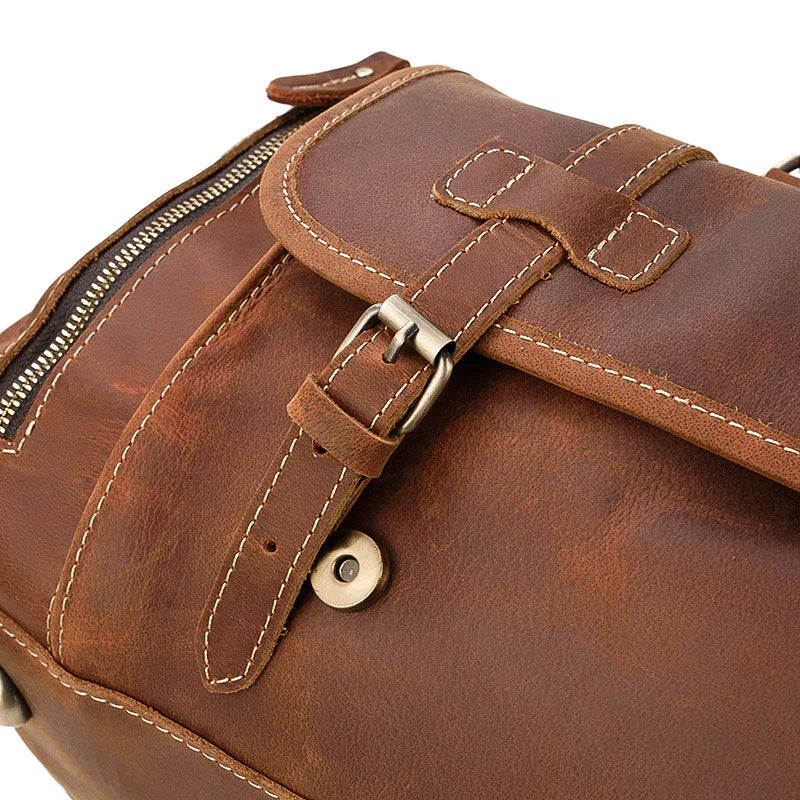 Handmade full grain brown leather duffle bag with buckle detail and contrast stitching