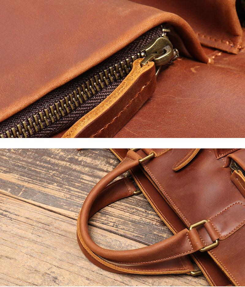 Close-up of handmade full grain leather messenger bag with brass zipper and sturdy handles on wooden surface