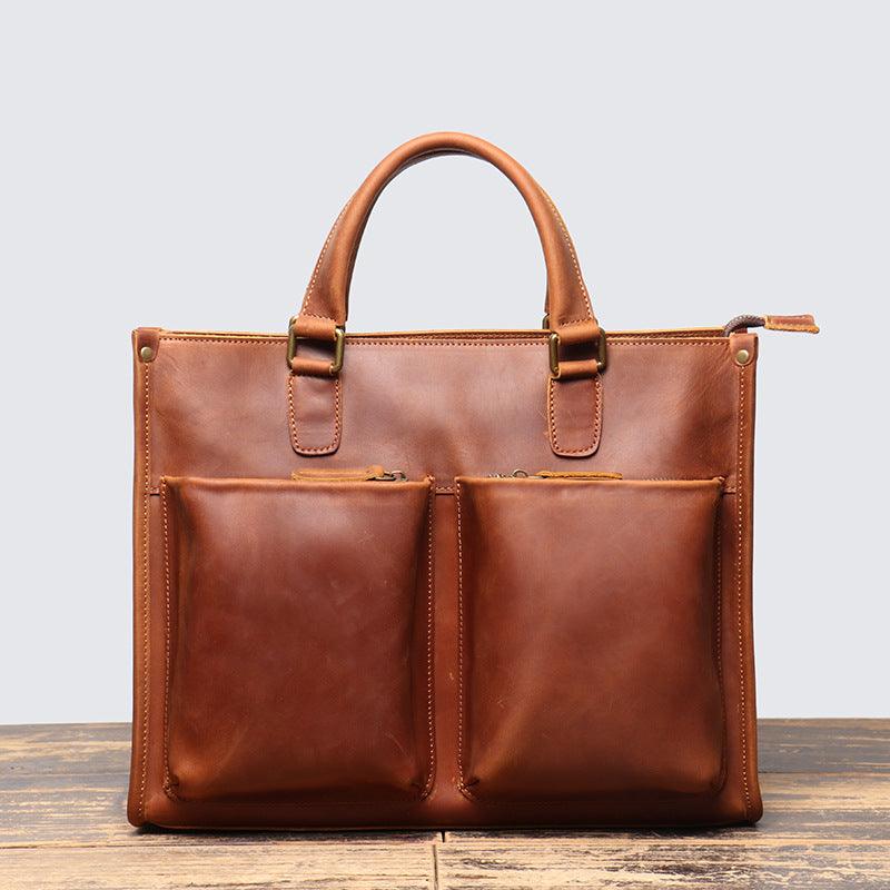 Handmade full grain leather messenger bag with dual front zip pockets and top handles