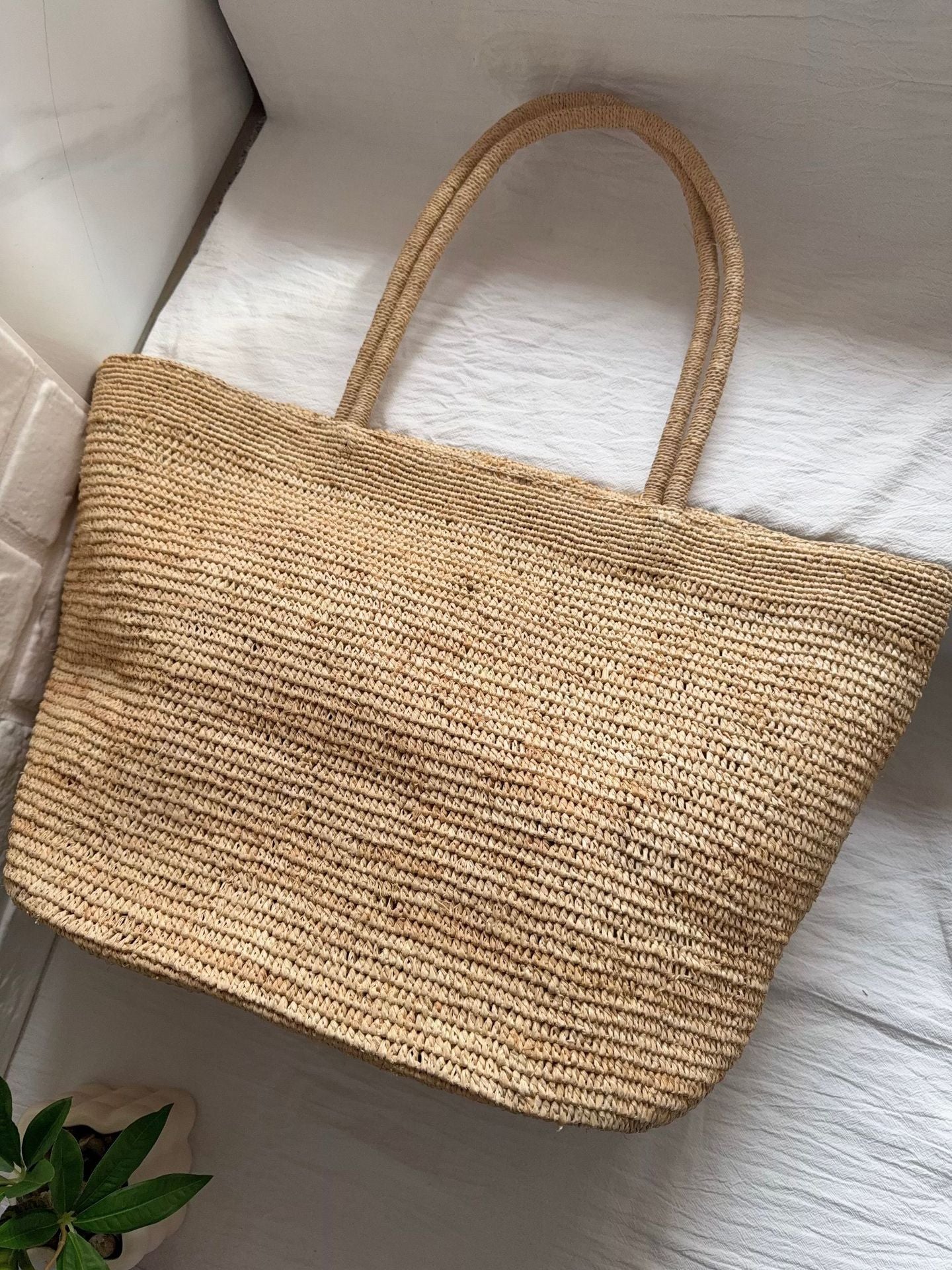 Handwoven raffia straw tote front view – large vacation beach bag natural colour women
