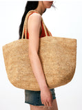 Handwoven raffia straw tote flat lay – natural fibre beach bag with woven handles and scarf