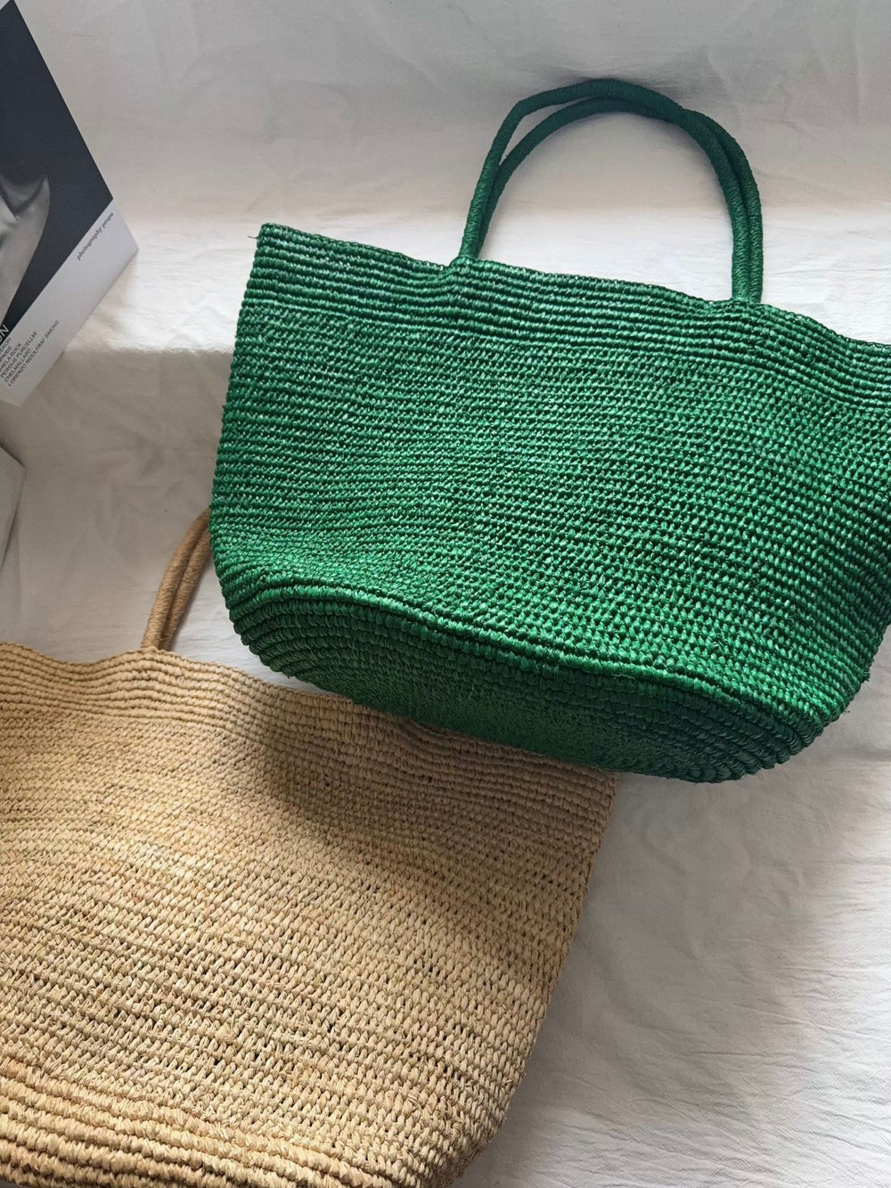 Raffia beach tote carried on arm – handwoven natural straw women's vacation bag lifestyle