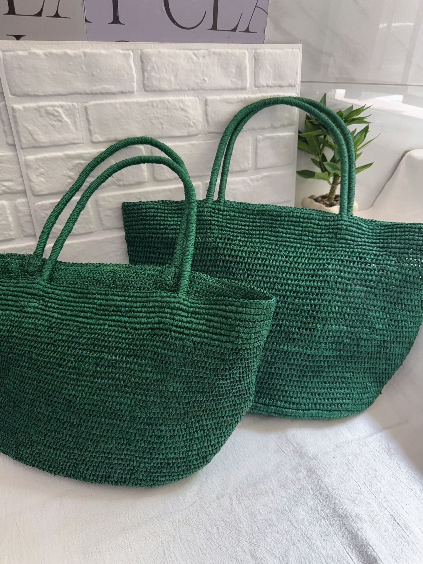 Handwoven raffia tote bag full back view – natural straw structured beach bag reinforced base