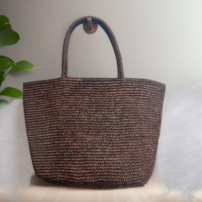 Raffia straw tote bag carried by handles – handwoven natural beach bag resort style women