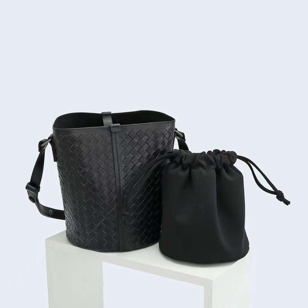Black woven lambskin leather bucket bag with adjustable strap and drawstring pouch insert