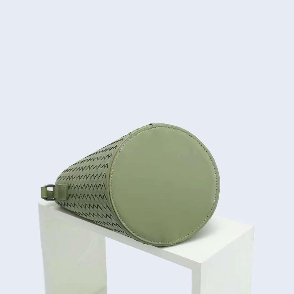 Green woven leather bucket bag with round base, displayed on a white block, modern style